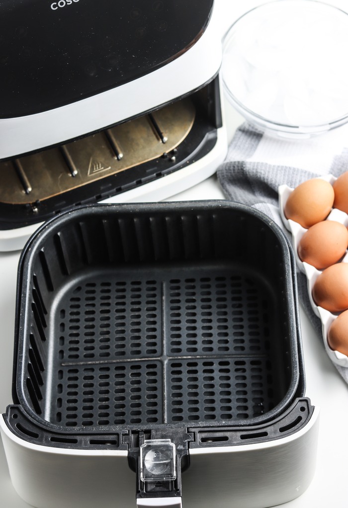 Air fryer basket ready to add eggs. 