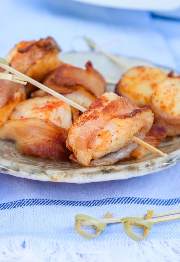 Cooked scallops on a serving dish. 