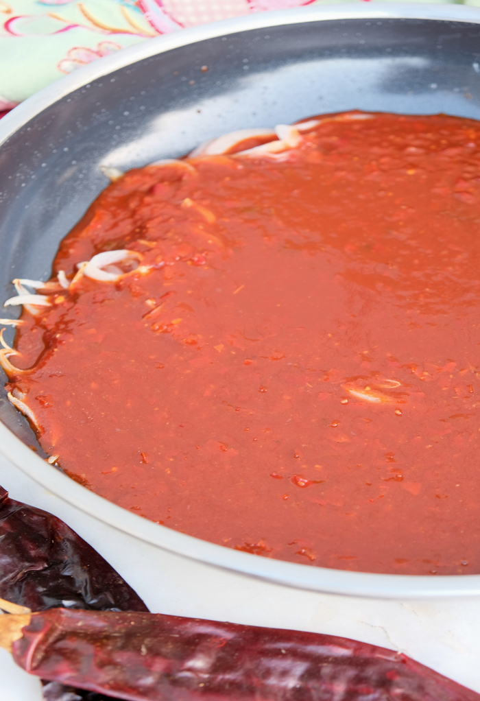 Simmering chile sauce in a skillet for chilaquiles.