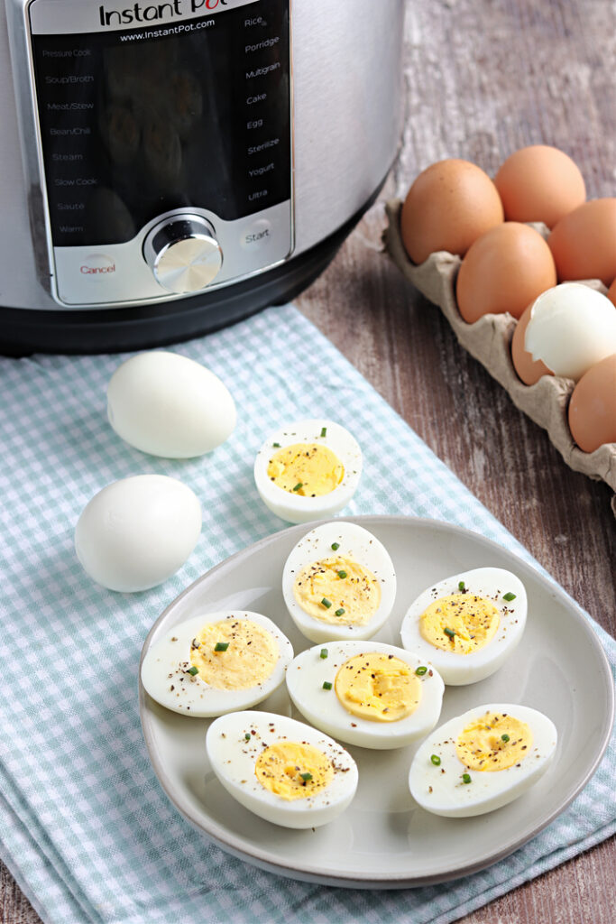 Hard boiled eggs cooked in an Instant Pot on a small plate. 