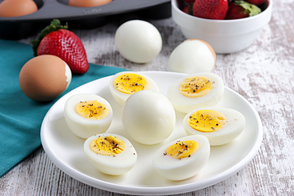 Fresh oven baked hard boiled eggs on a white plate. 