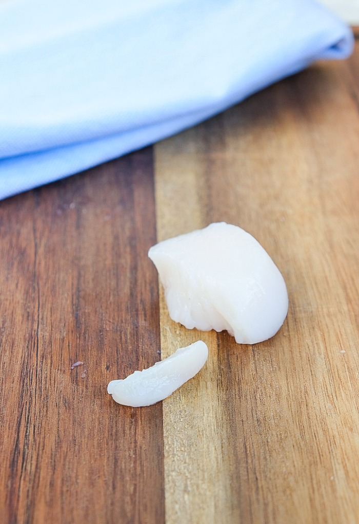 The soft muscle on the side of a scallop removed.