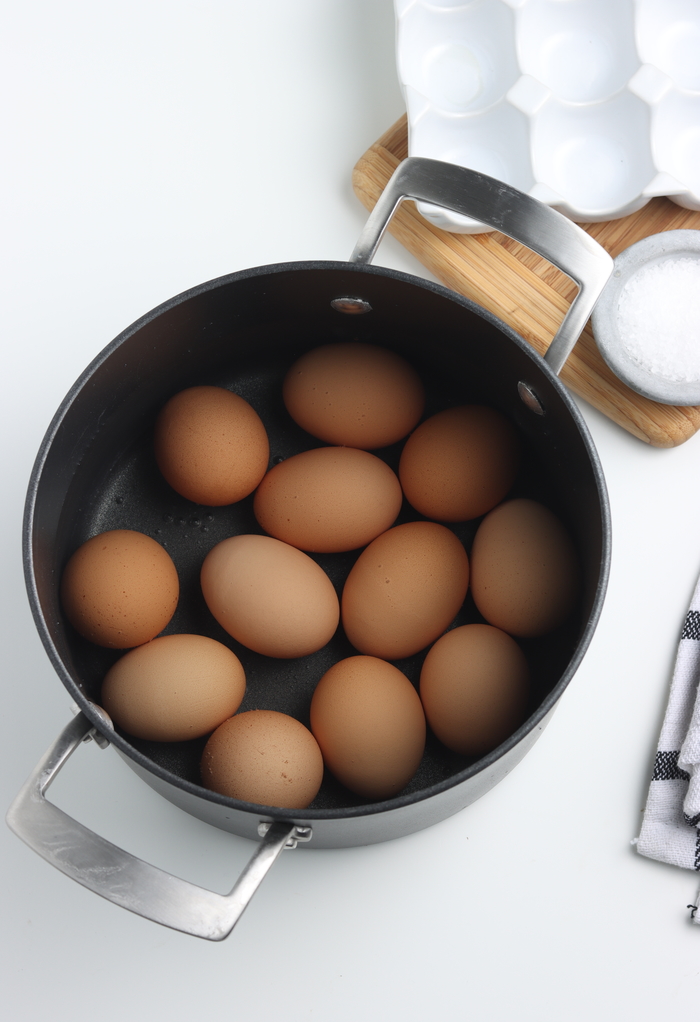 Eggs placed in a pot before adding water to boil.