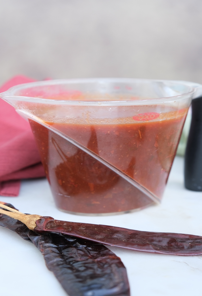 Homemade chilaquiles sauce in a measuring cup. 