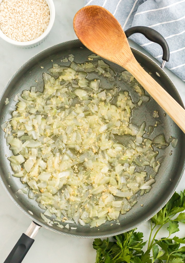 Sautéing spices and onion in a large skillet. 