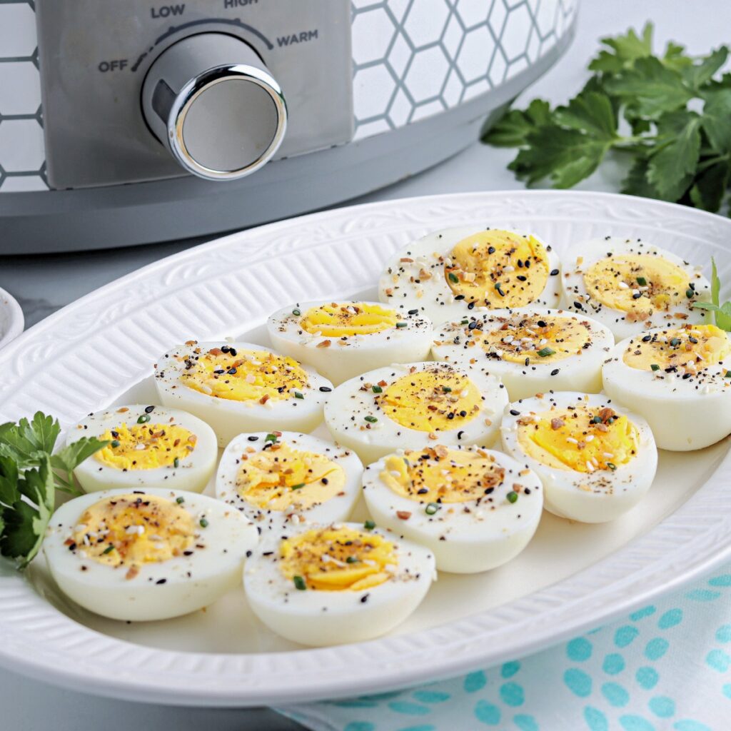 Hard boiled eggs on a white serving dish ready to eat.