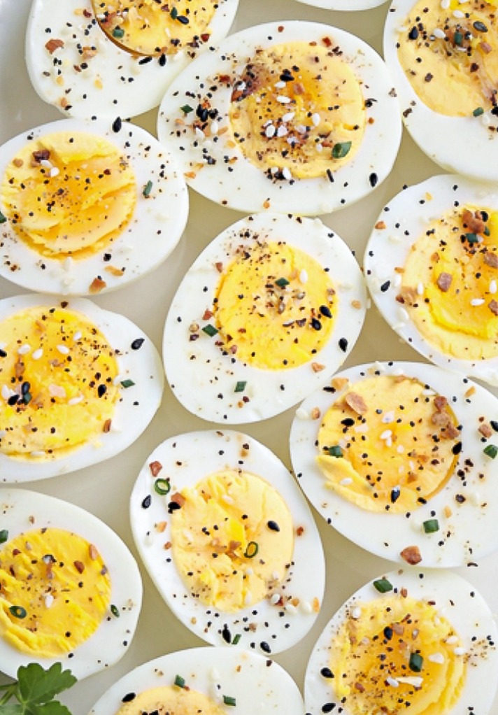 Close view of hard boiled eggs topped with everything bagel seasoning. 