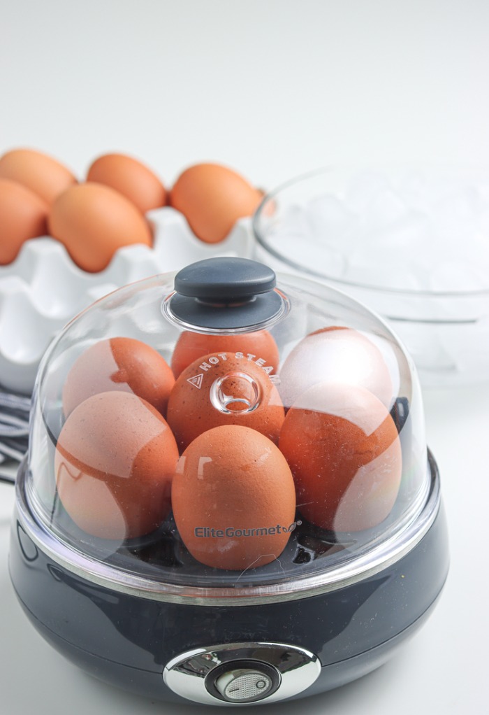 Cover on egg cooker with eggs cooking. 