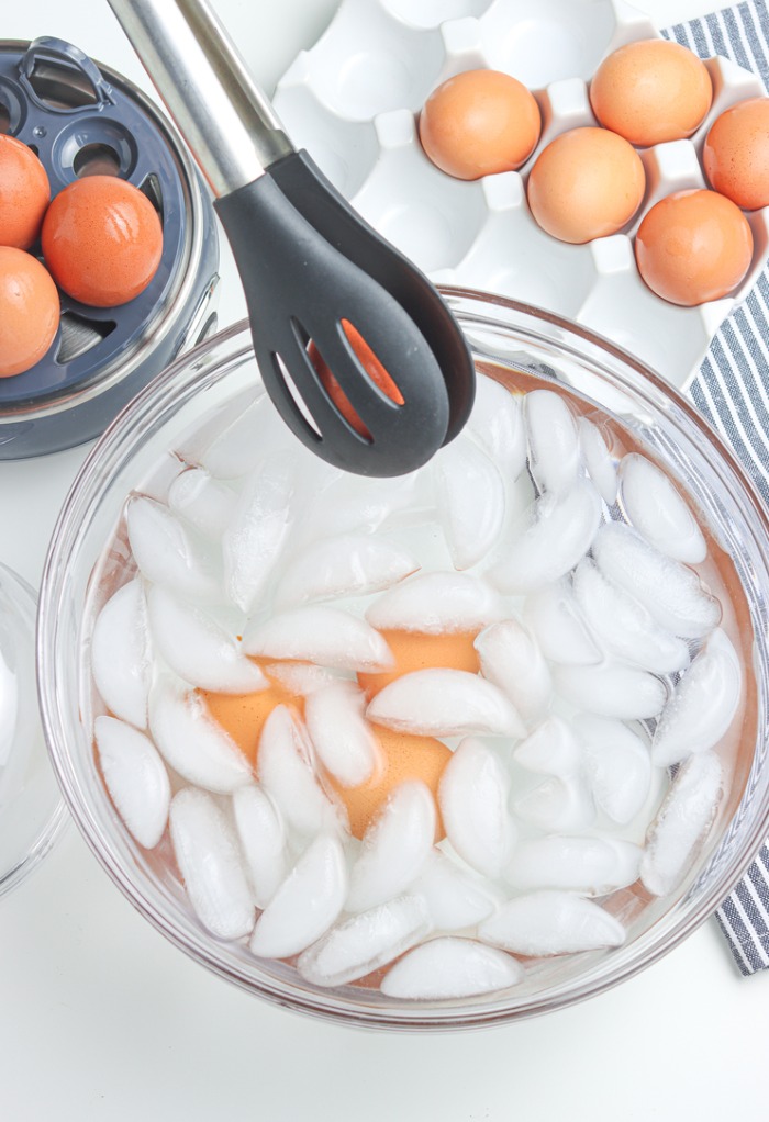 Cooked hard boiled eggs in a ice water bath. 