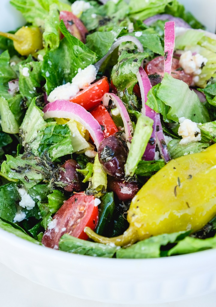 Close view of copycat Panera Greek salad recipe in a mixing bowl ready to eat. 