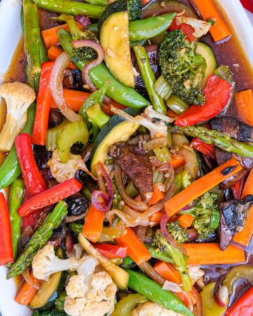 Top view of vegetable stir fry on a white serving plate.