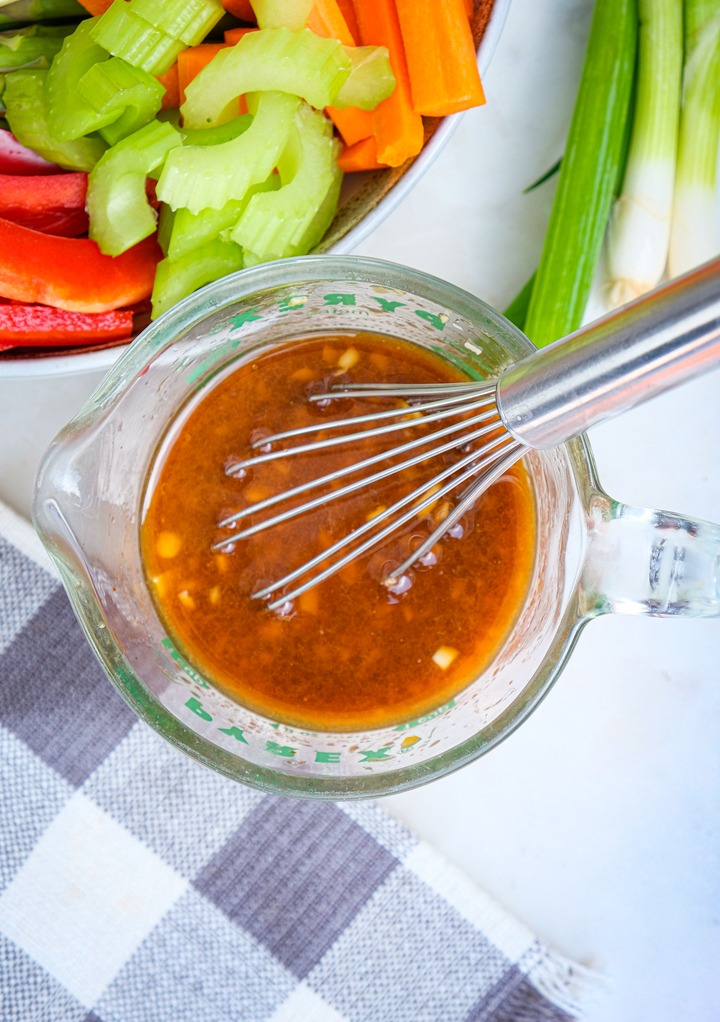 Stir fry sauce whisked in a glass measuring cup.