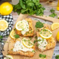 air fryer parmesan crusted salmon on a brown cutting board.