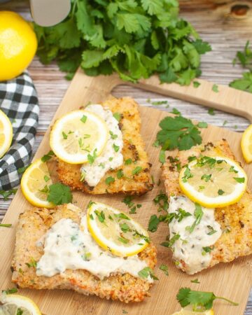 air fryer parmesan crusted salmon on a brown cutting board.