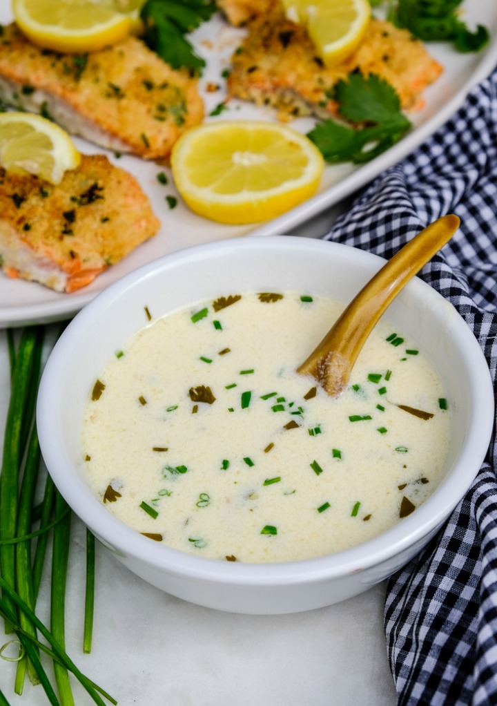 White wine sauce in a white serving dish ready to add to fish. 