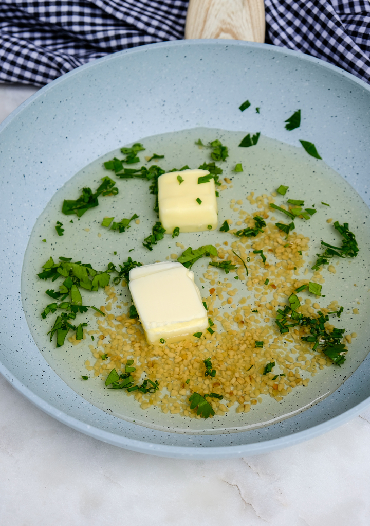 White wine sauce ingredients in a skillet before cooking. 