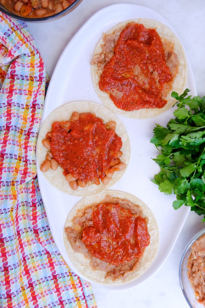 Ranchero sauce over the refried beans.