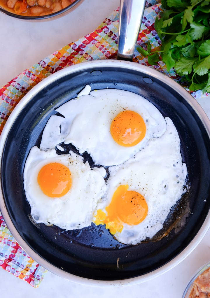 Cooked sunny side up eggs in a large skillet.