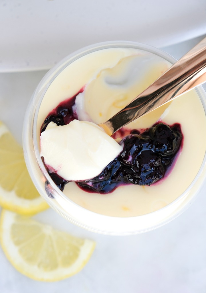 Lemon dessert with a spoon scooping a bite out. 