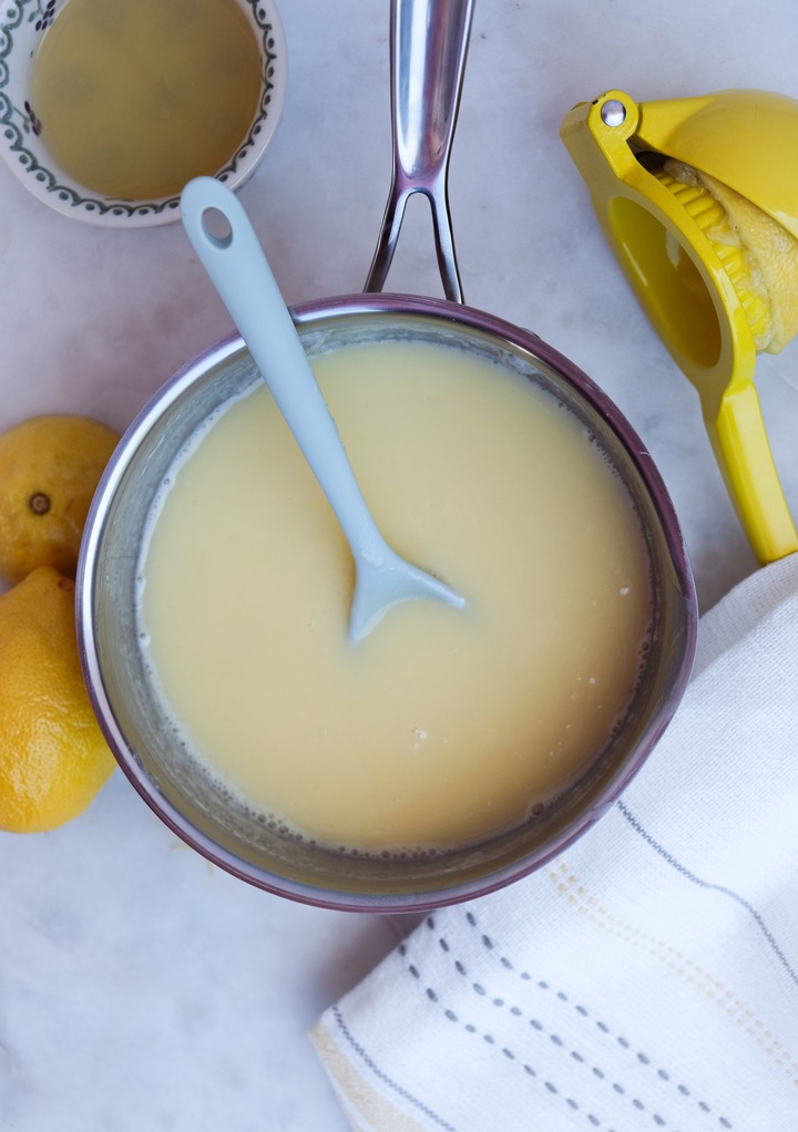 Lemon posset that has been cooked in a small silver saucepan. 