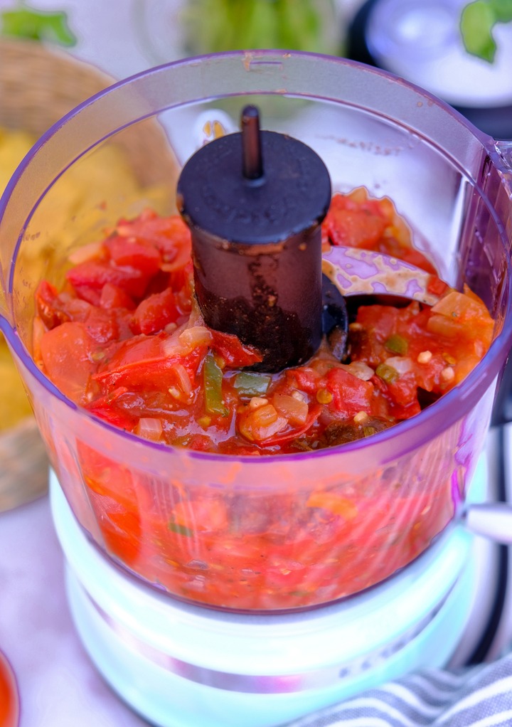 Chunky salsa in a mini food processor before blending. 