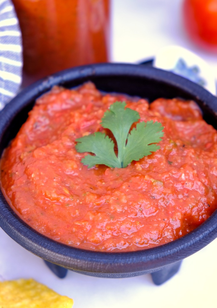 Blended red salsa in a black dipping bowl. 