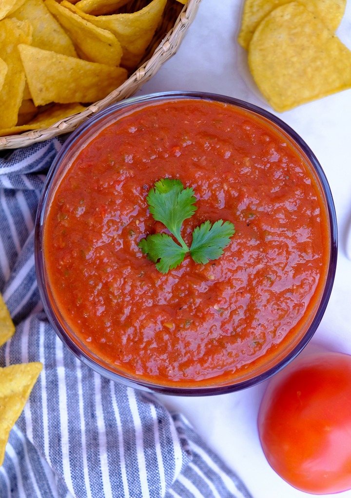 Top view of homemade ranchero sauce with tortilla chips on the side.  