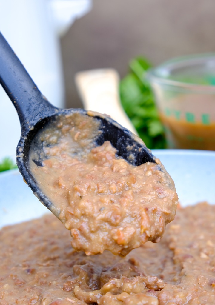 A A black spoon of refried beans.