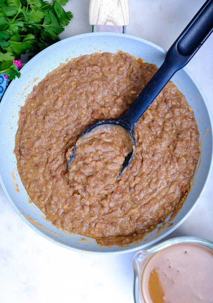 Top view of refried beans simmering. 