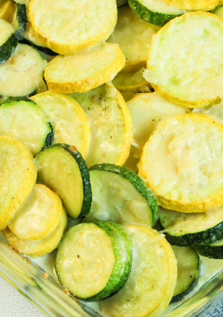 Close view of cooked zucchini and squash cut in round circles with cheese. 