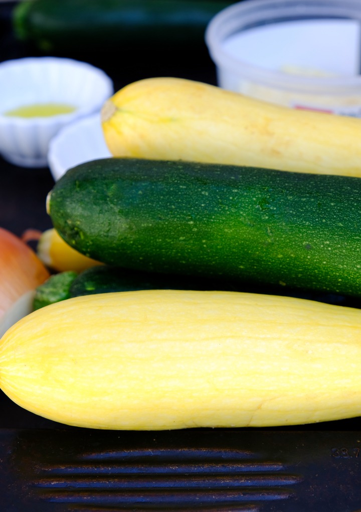 Fresh zucchini on a metal tray.