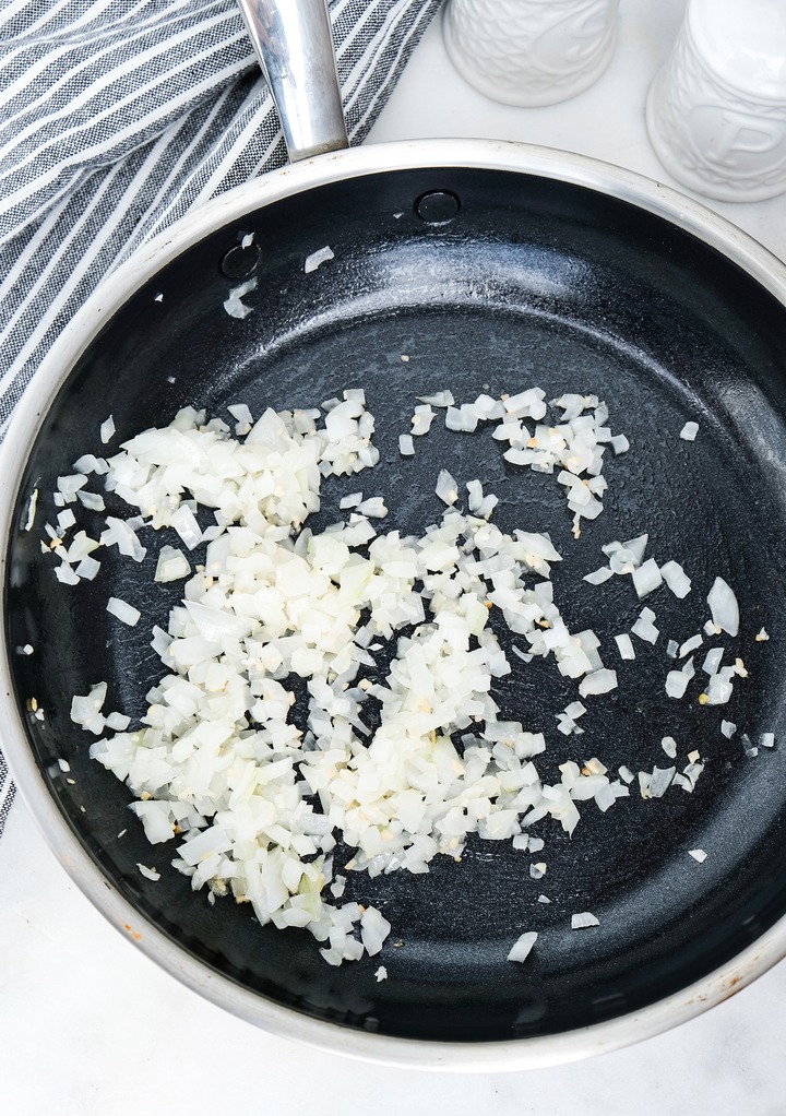 Cooking diced onion in a skillet.