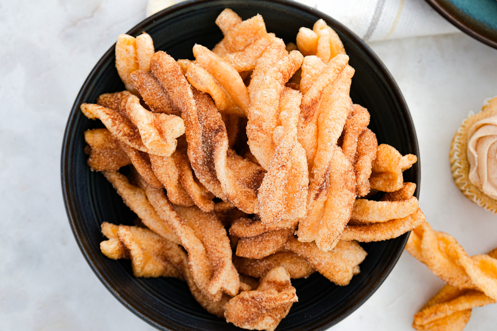 Top view of cinnamon twists on a dark plate. 