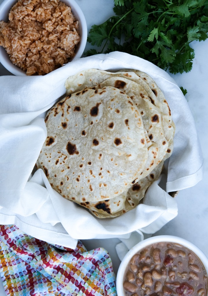 Top view of flour tortilla recipe without lard with rice and beans.