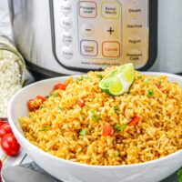 Homemade Mexican rice made in an Instant Pot in a white serving bowl.