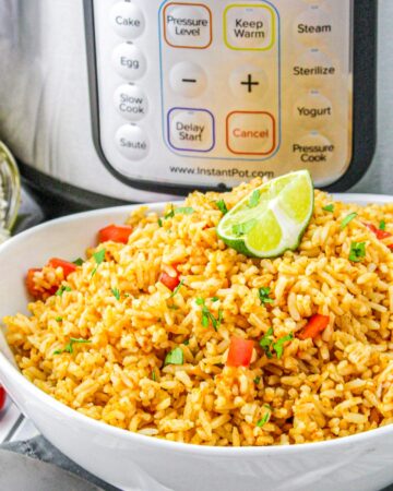 Homemade Mexican rice made in an Instant Pot in a white serving bowl.