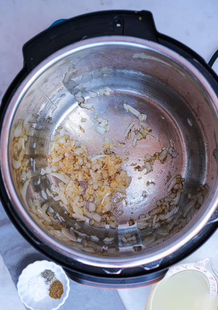 Saute onions and garlic in an Instant Pot.