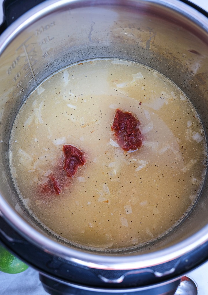 Adding tomato past on rice mix to make Spanish rice. 