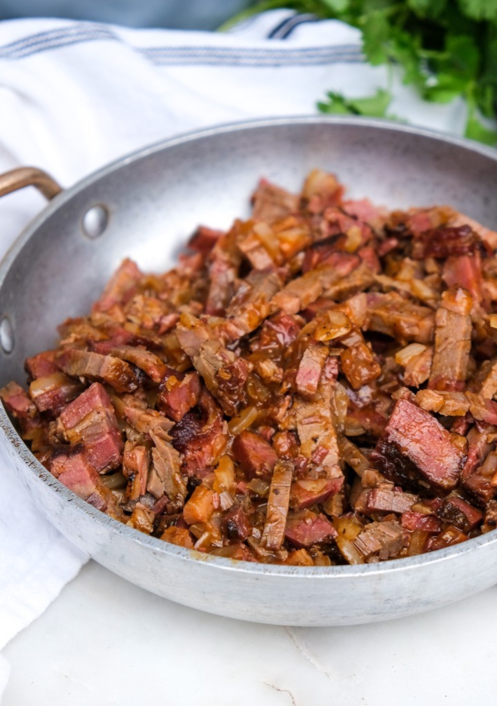 Cooked leftover brisket taco filling ready to assemble in tacos. 