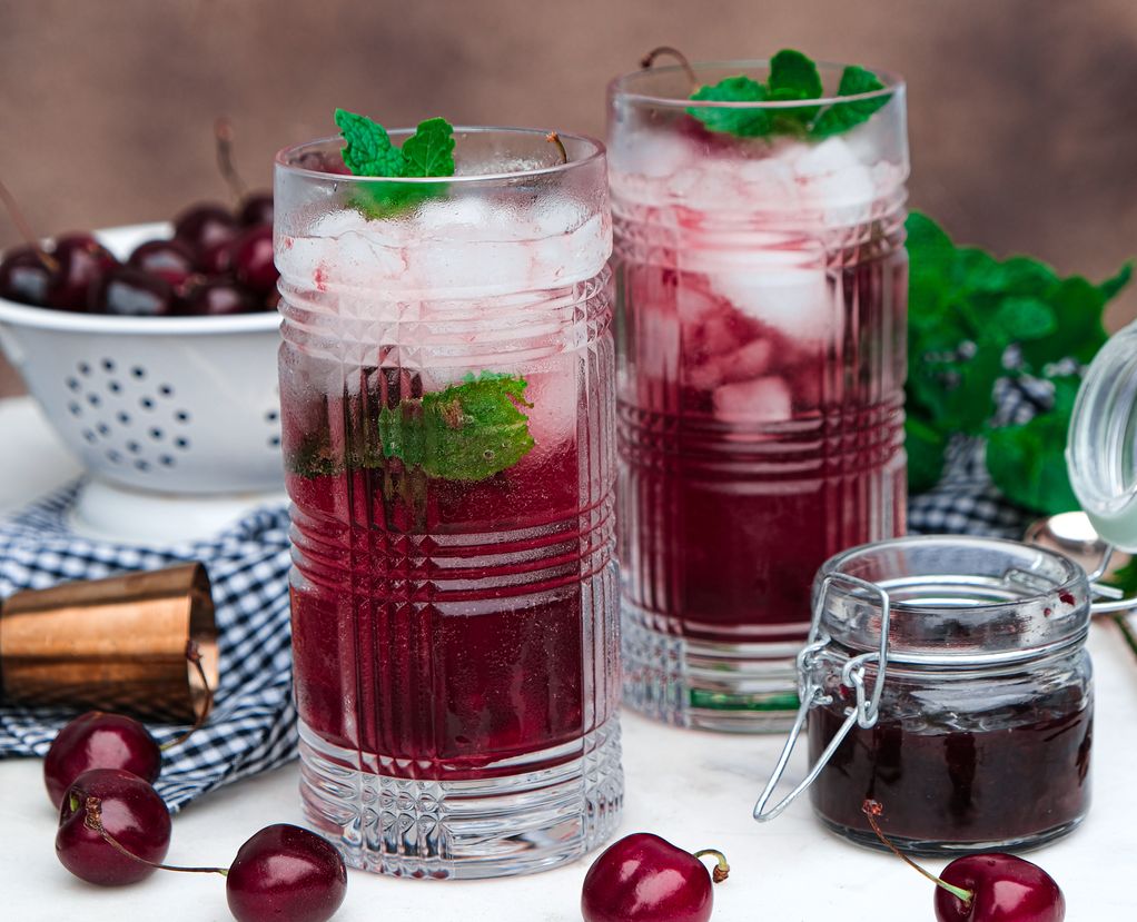 Cherry mojitos in tall clear glasses ready to drink. 