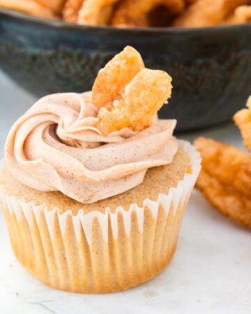 Churros cupcake topped with a cinnamon twist ready to eat.