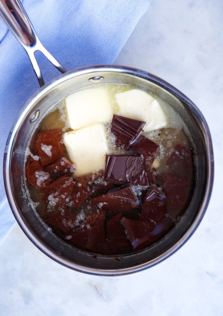 Ingredients to make chocolate sauce in a small saucepan before cooking.