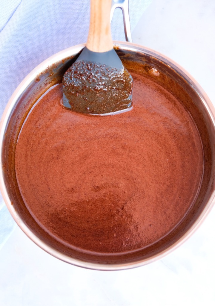 Melted homemade Ghirardelli chocolate sauce in a small saucepan.  