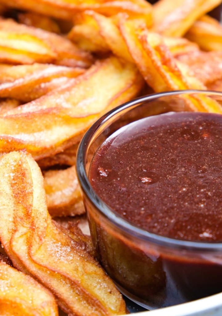 Ghirardelli chocolate sauce recipe with churros on the side ready to dip in the chocolate. 