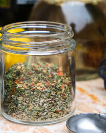 Italian dressing mix spices in a small clear jar.
