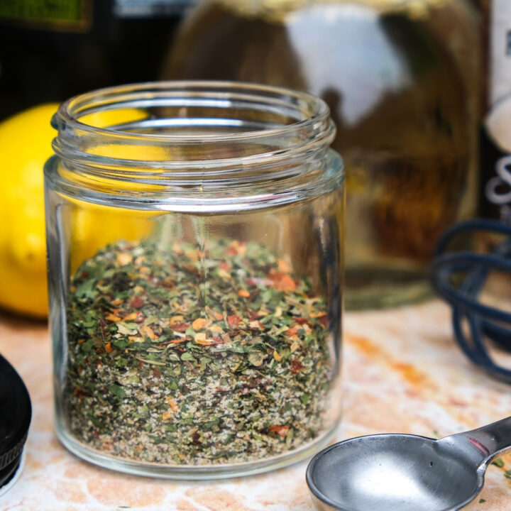 Italian dressing mix spices in a small clear jar.