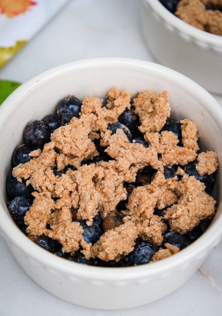 Sugar free blueberry crumble in a small white bowl. 