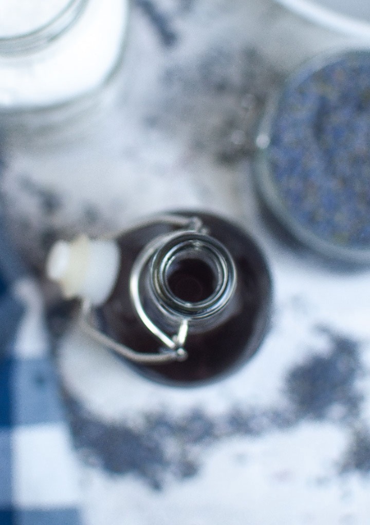 Overhead view of a glass gar of lavender syrup.