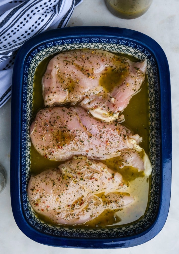 Marinating chicken in a casserole dish. 