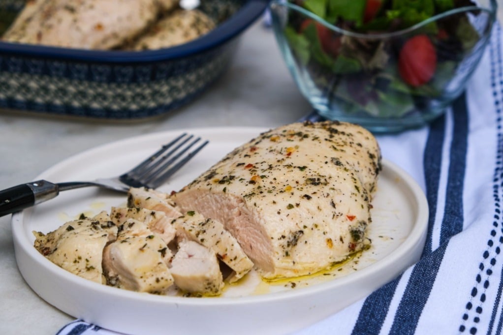 Skinless chicken breast on a dinner plate. 